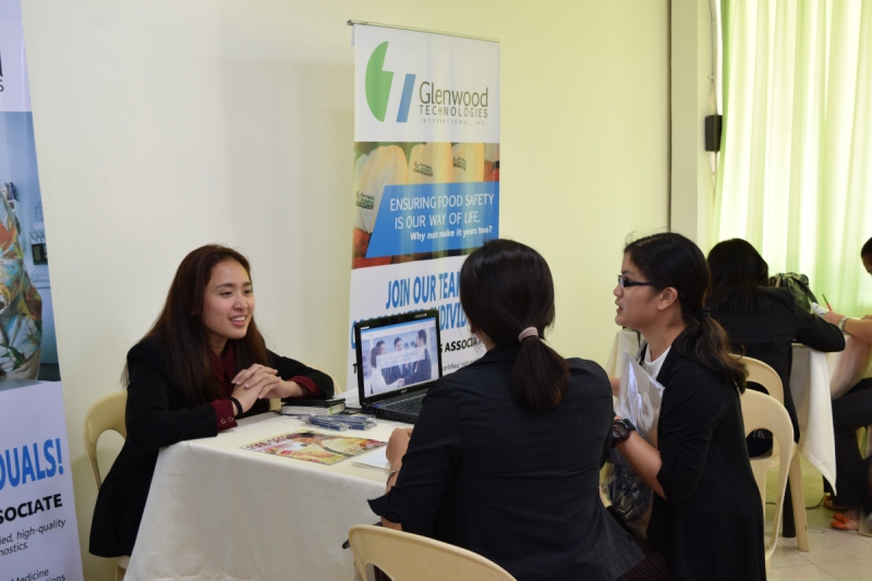 A company representative interviews graduating students during the University Job Fair.