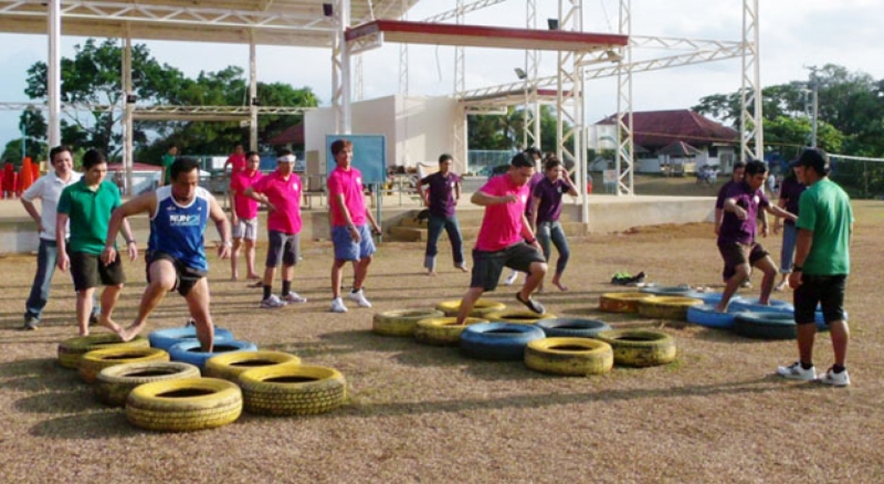 OSA personnel race through obstacles as part of their team building activities.